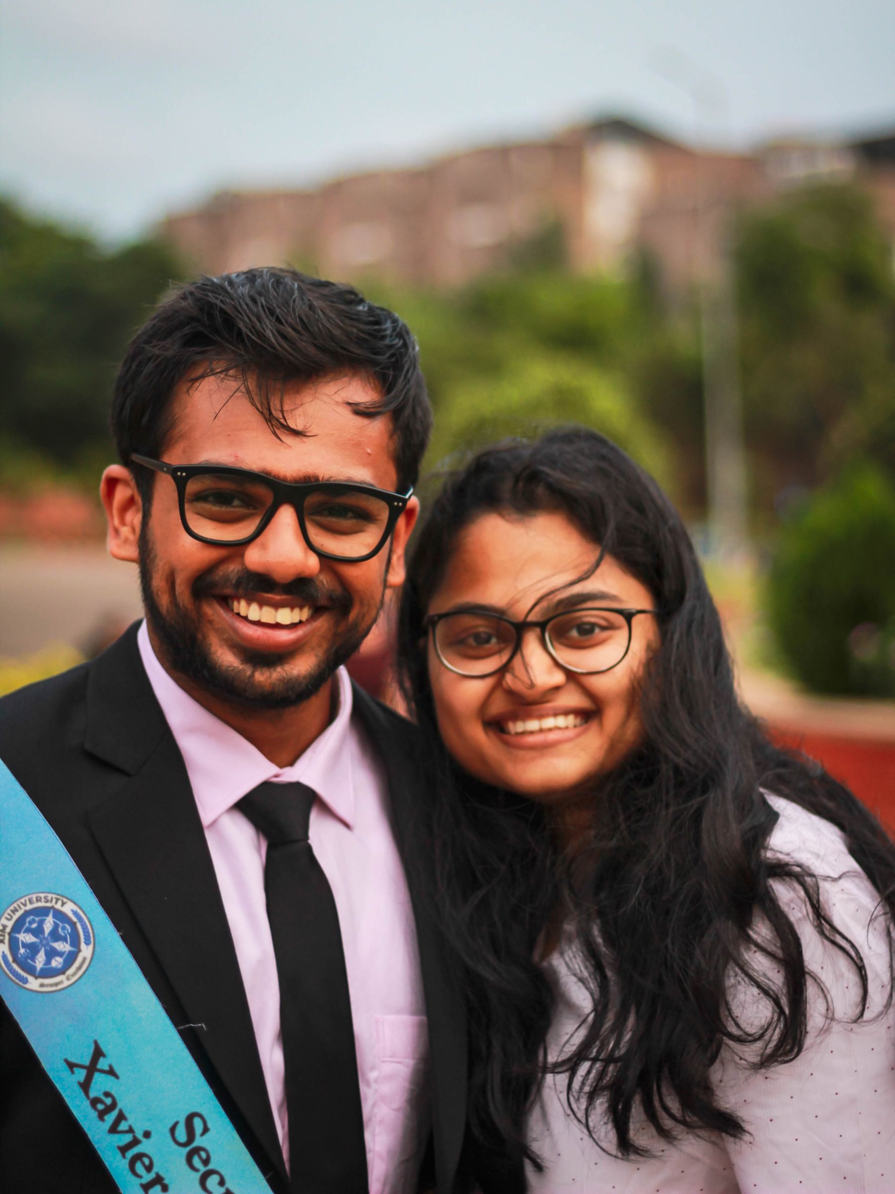 Two young Indian graduates smiling at their convocation
