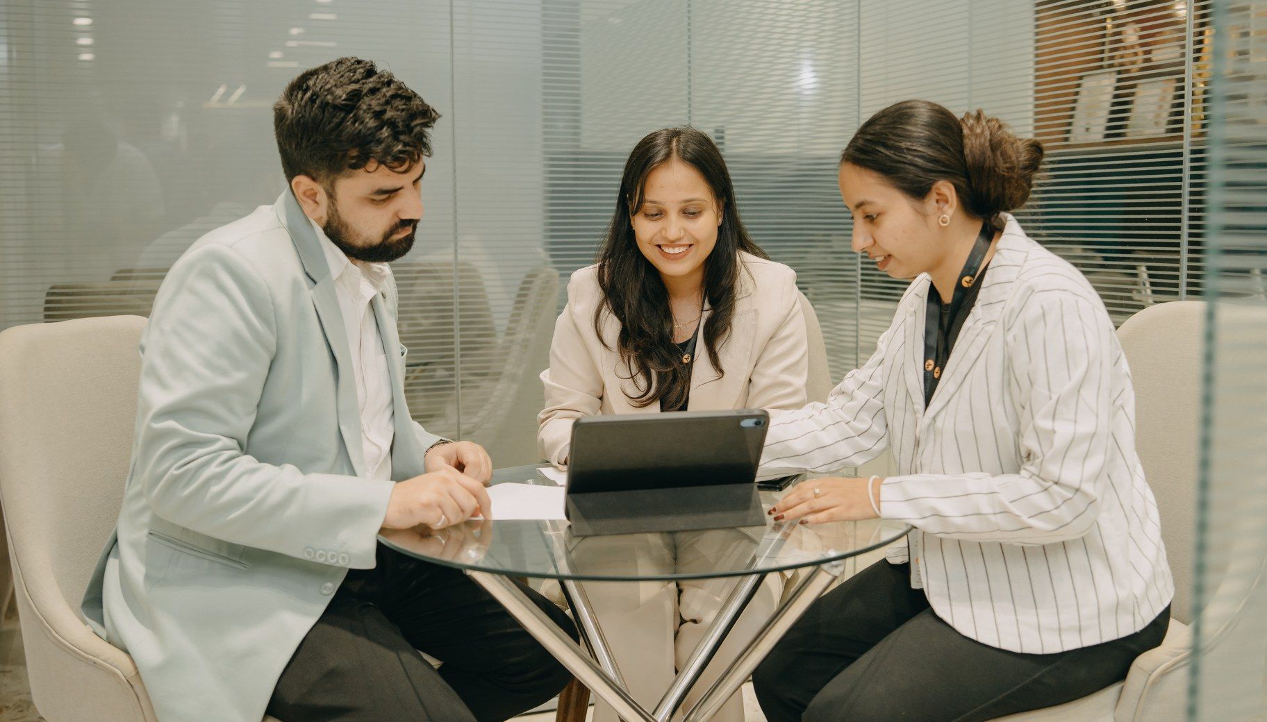 Wethonic relationship managers reviewing a client portfolio on a tablet