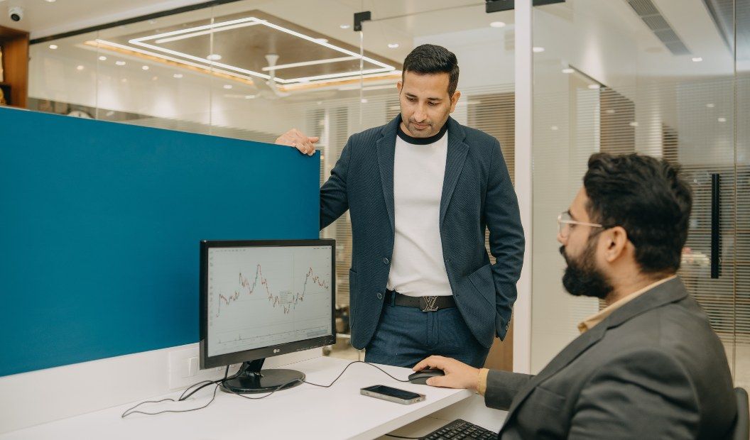 Wethonic team reviewing a market chart on a monitor